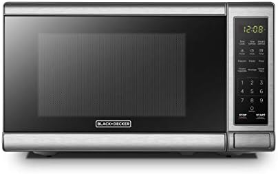 Angled view of the BLACK+DECKER EM720CB7 microwave with its push-button door open, revealing the turntable.