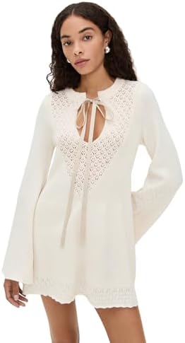 A woman in a Free People Bali Old Flame Sweater Dress walks on a scenic path.